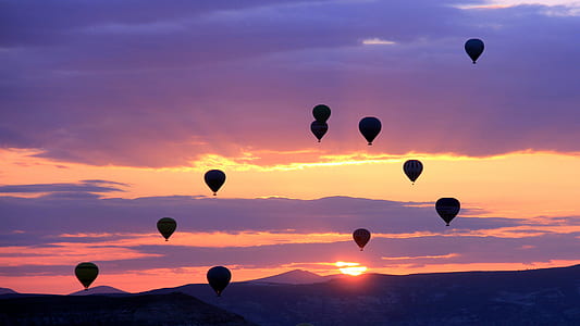 silhouette photo of air balloons during golden hour thumbnail
