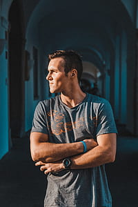 man in gray crew-neck shirt standing on corridor thumbnail