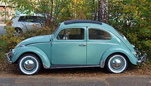 teal Volkswagen Beetle park near treee thumbnail