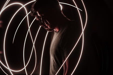 man surrounded of white LED string lights thumbnail