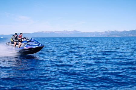 two men riding personal watercraft on blue calm sea at daytime thumbnail