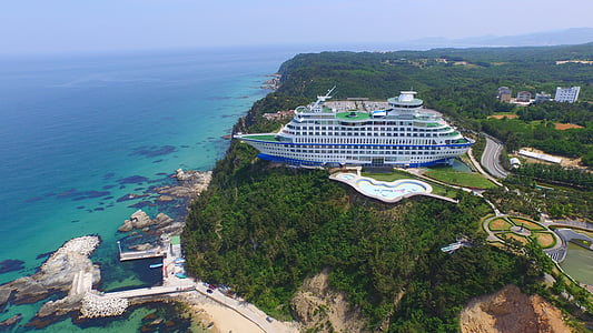 bird's eye view photography of cruise ship building thumbnail