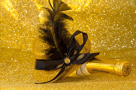 closeup photo of liquor bottle with feather decor thumbnail