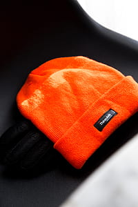 closeup photo of orange Thinsulate knitted cap thumbnail