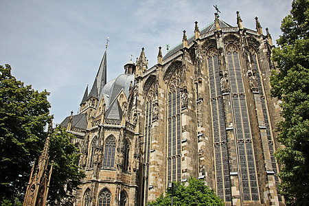 brown and gray cathedral surrounded by green trees during daytime thumbnail