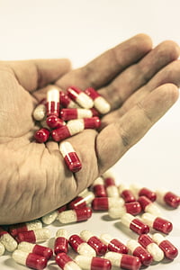 medicine capsules on person's hand thumbnail