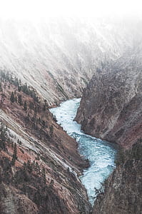 aerial photography of river between brown rock formations thumbnail