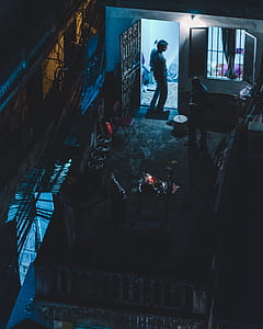 man in grey shirt stands on open door thumbnail