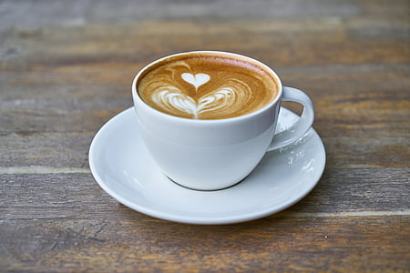 white ceramic teacup with saucer filled with cappuccino thumbnail