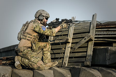 soldier holding black sniper rifle thumbnail