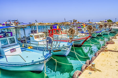 assorted-color boat on body of water near dock thumbnail