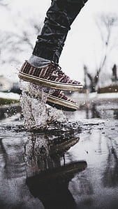 shallow focus photography of person jumping on body of water thumbnail