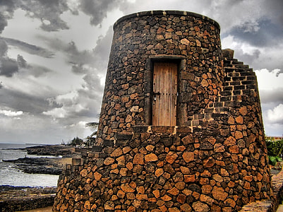 photo of stone-built building near body of water thumbnail