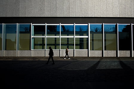 two men walking in front of building thumbnail
