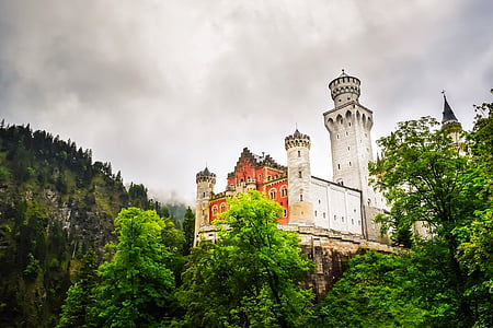 orange and white building surrounded by trees thumbnail