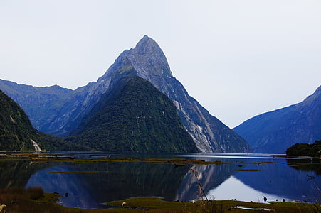 body of water near mountain photography thumbnail