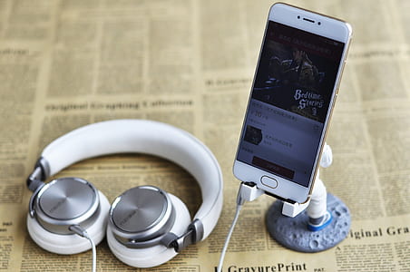 white Android smartphone with white and gray corded headphones plug in thumbnail