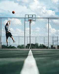 man shooting on basketball hoop thumbnail