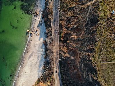 aerial view photography of sea near green grass field at daytime thumbnail