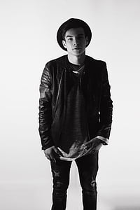 grayscale photo of man oin leather jacket and hood thumbnail
