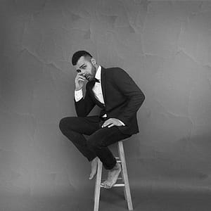 Monochrome Photography of Guy Sitting on Chair thumbnail