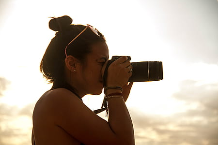 woman holding DSLR camera thumbnail