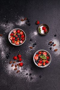 sliced strawberries and blueberries on bowl thumbnail