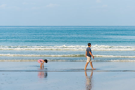 person wearing black crew-neck shirt and brown short while walking on water thumbnail