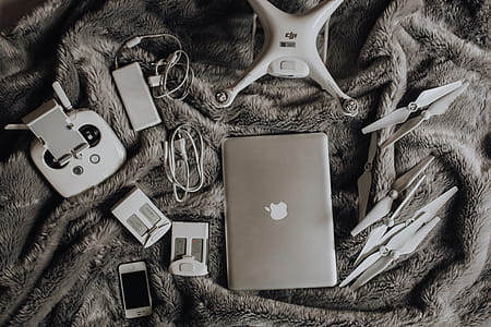 Drone, laptop and accessories lie on the bed ready for travel thumbnail