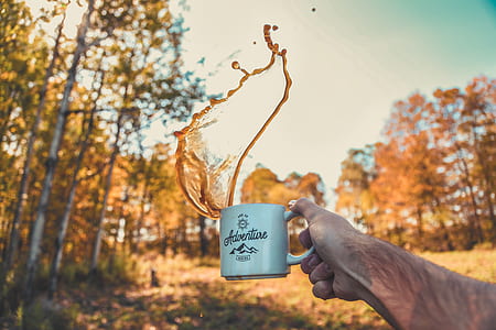 person's hand holding mug thumbnail