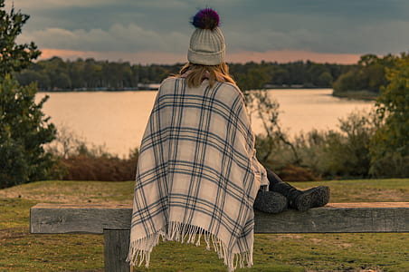 woman sitting on gray wooden bench thumbnail