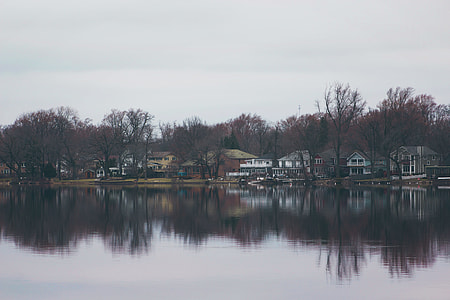 calm body of water near house thumbnail