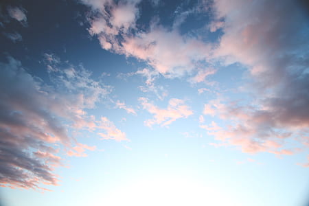 worm's eye view of semi cloudy sky during daytime thumbnail
