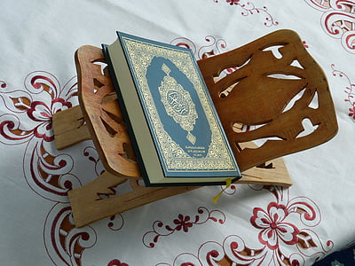 green and gold hardbound book and brown wooden holder thumbnail