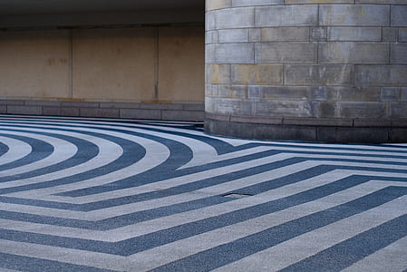 white and blue lined road beside gray concrete wall thumbnail