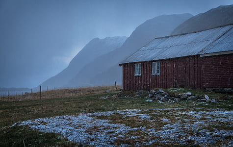 barn at the field with mountains at the distance thumbnail
