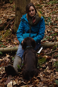 woman wearing windbreaker jacket facing the dog thumbnail