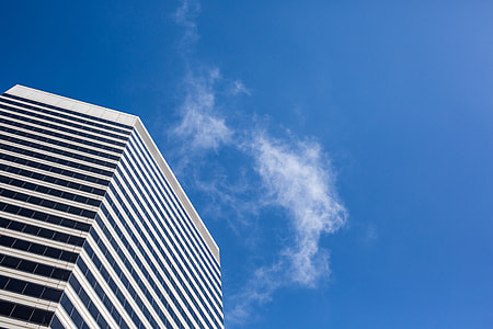 Clean Skyscraper View from Below Against a Blue Sky thumbnail