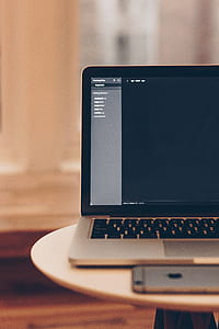 gray laptop computer on top white table thumbnail