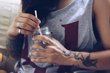 woman holding mason jar with straw thumbnail