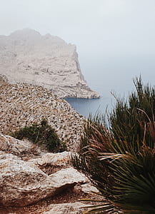 mountains and body of water during daytime thumbnail