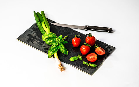 tomatoes with knife at the chopping board thumbnail