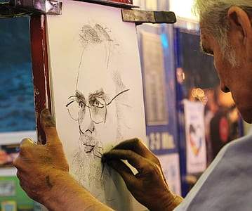man sketching bearded man on white paper thumbnail