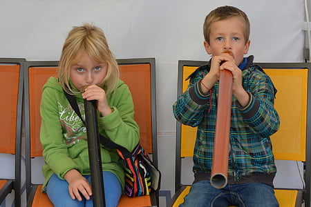 boy and girl blowing on pipe thumbnail
