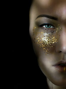 closeup photo of woman's face with glitters thumbnail