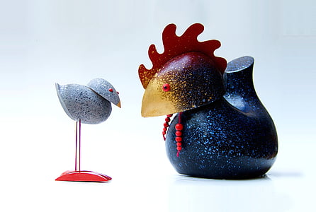 gray chick and blue rooster figurines on white top thumbnail