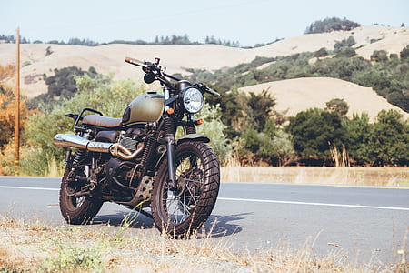 black cruiser motorcycle on gray road thumbnail