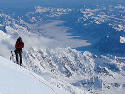 person standing on snowy mountain during day time thumbnail