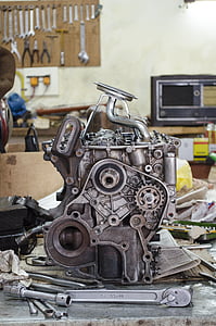 grey metal vehicle engine with handheld tools thumbnail