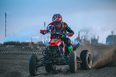 person riding on ATV on road thumbnail